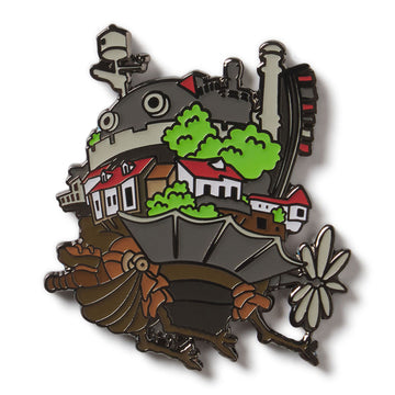 Enamel pin with a design of a character holding a suitcase, houses, and trees on a white background Howl's Moving Castle Studio Ghibli Exclusive Lapel Enamel Pin Academy Museum